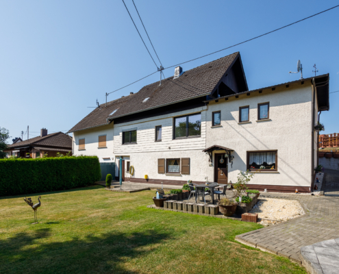 Rückansicht Immobilie mit großer Gartenfläche Rückansicht der Immobilie und Blick auf den gepflegten Rasen