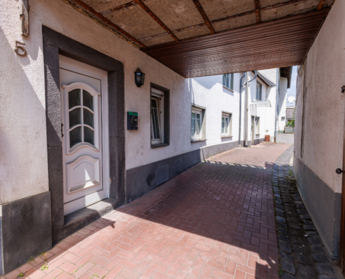 Hausansicht mit Balkon mit Schuppen und Balkon über der Gasse